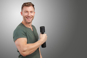 Portrait of a muscular man lifting weight