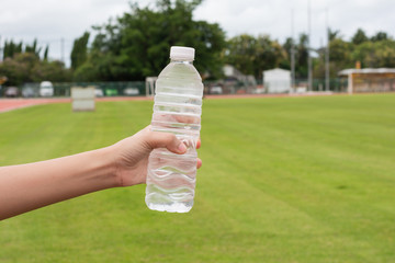 Hand of healthy woman Holding fresh water  bottle