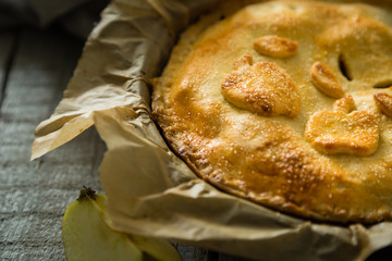 Apple pie on rustic wood background