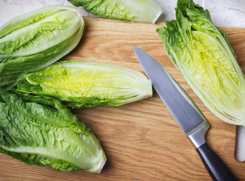Romain lettuce on kitchen board