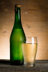 Apple cider in glass bottle with water drops