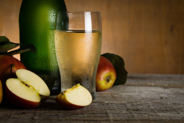 Apple cider in glass bottle with water drops