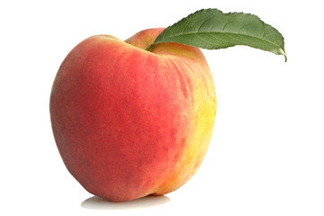 Ripe peach with a leaf on a white background isolated