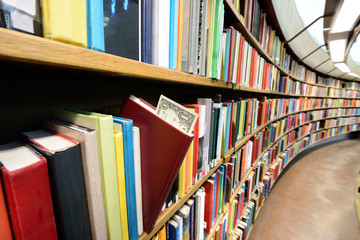 Book with dollar bill in library