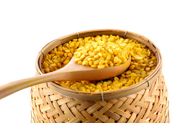 Pile of skinless mung beans in spoon and basket on white backgro