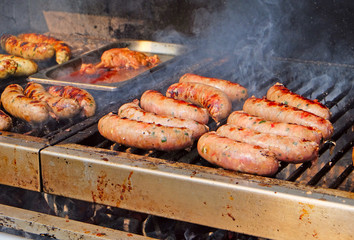 preparing sausages on the grill
