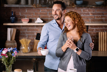 Wife and husband standing in kitchen