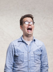 Portrait of a shocked, screaming, stunned or surprised young man