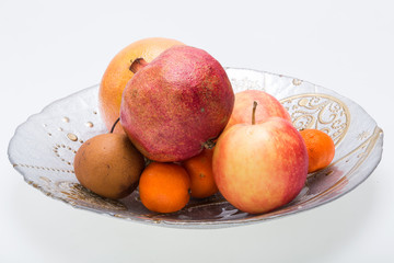 mix fresh fruits on plate isolated on white