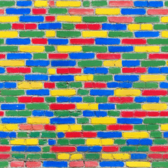 Seamless texture of bricks wall of different bright colors: yellow, red, green, blue.