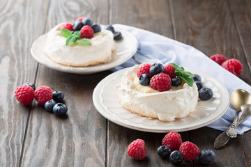 Pavlova cake with fresh summer berries, selective focus