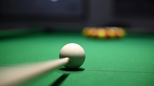 Color footage of a person missing the shot during a billiards match.