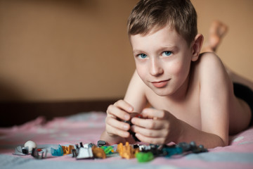 little boy playing with toys;