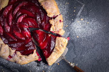 plum  galette on dark background