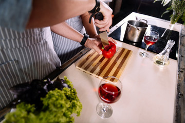Hands of man cutting paprika