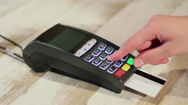 Inserting credit card into card machine and dialing pin code