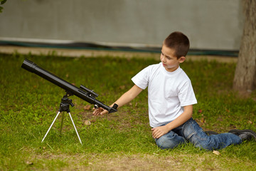 happy little boy with telescope