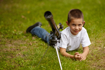 happy little boy with telescope