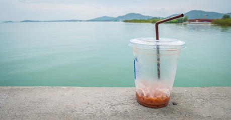  ice chocolate in plastic glass with sea view