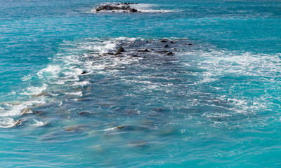 Waves, rocks and stones on the open sea