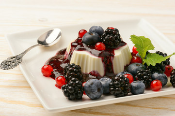 Panna cotta with berry mousse and berries.