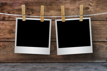 Clothespin hanging with blank photo papers.