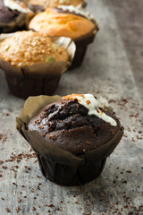 Variety of muffins on a rustic wooden table

