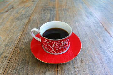 Black coffee cup on old wooden table