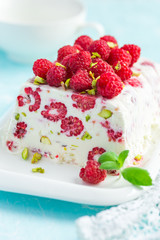 semifredo, italian ice cream dessert, with raspberry and pistach