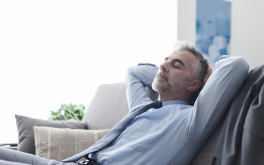 Businessman sleeping on the couch