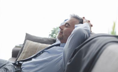 Businessman resting on the sofa