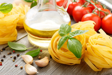 Fettuccine with basil leaf on wooden table