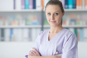 Young practitioner posing in the office