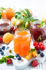 assortment of sweet jams and seasonal fruits, vertical