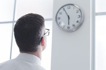 Businessman staring at the clock