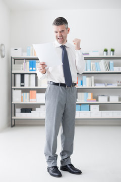 Cheerful businessman receiving good news