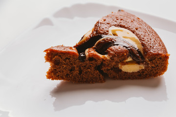 piece of cake with truffle filling close-up on a white plate