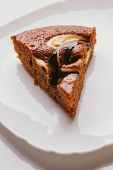 piece of cake with truffle filling close-up on a white plate