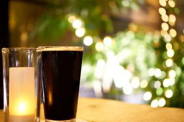 glass of dark beer in pub or restaurant
