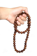 Holding Buddhist prayer beads isolate on white background