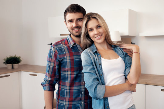 Smiling young couple in new kitchen