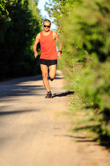 Man running on country road and training