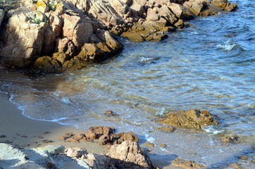 blue sea breaking on the rocks