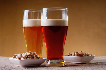 Glasses of beer and pistachio nuts