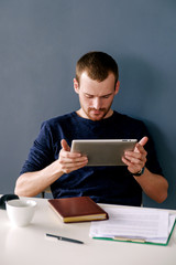 Bearded man using tablet at work