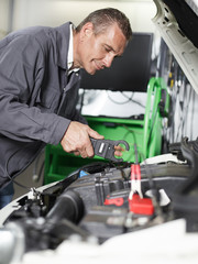 Car mechanic checks a car