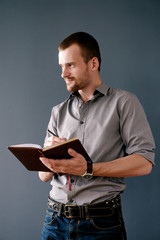 Successful bearded businessman with planner and pen