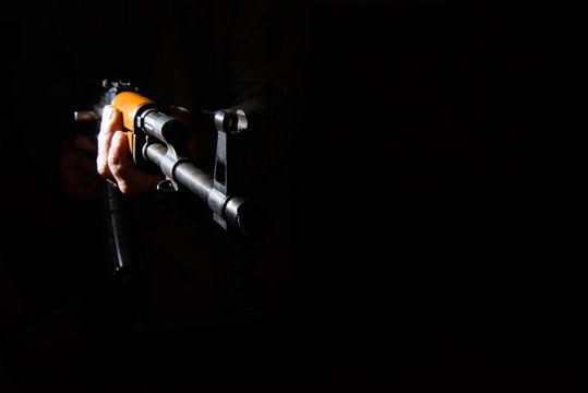 Kalashnikov assault rifle close-up in the dark
