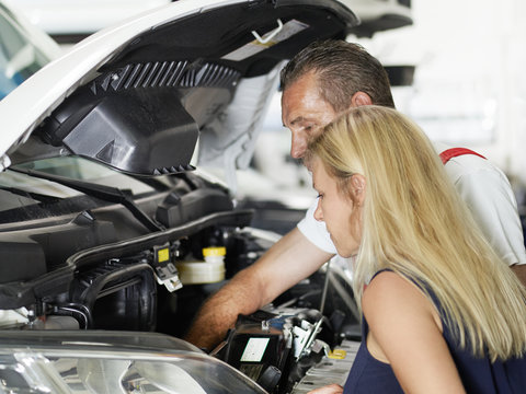 Customer and mechanic in a garage