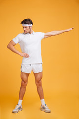 Concentrated young man athlete standing and working out